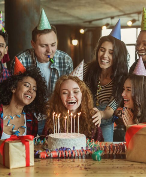 Happy friends congratulating girl on surprise birthday party, copy space