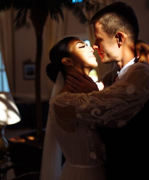Young married couple in darkness. Newlyweds enjoy each other tenderly. Romantic moment.