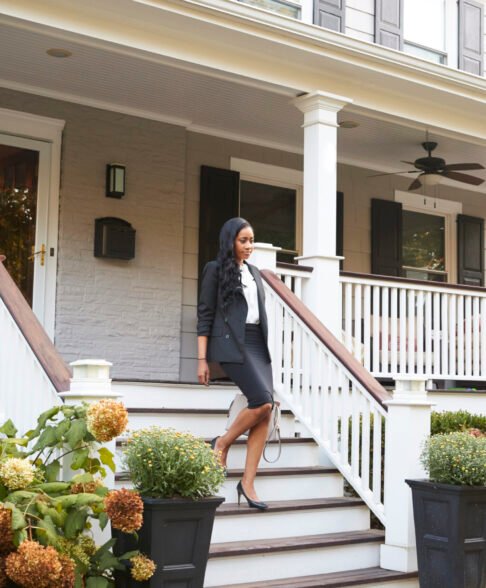Businesswoman Leaving Suburban House For Commute To Work