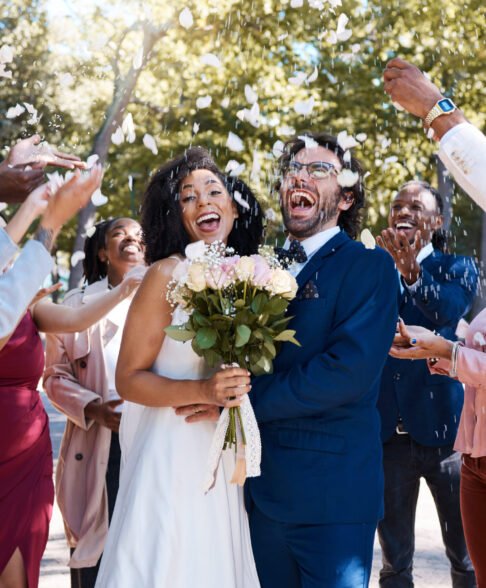 Wedding confetti, marriage couple and celebration of audience throwing flower petals outdoor. Happi.